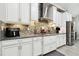 Modern kitchen with stainless steel appliances and stylish backsplash at 5802 Alabaster Stone Ln, Apollo Beach, FL 33572