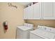Laundry room with washer, dryer, and ample cabinet space at 808 3Rd W Ave # 514, Bradenton, FL 34205