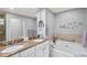 Double vanity bathroom with a large soaking tub and granite countertop at 808 3Rd W Ave # 514, Bradenton, FL 34205