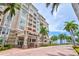 Condo building entrance with palm trees and landscaping at 808 3Rd W Ave # 514, Bradenton, FL 34205