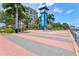 Brick paved walkway with palm trees and a modern building in the background at 808 3Rd W Ave # 514, Bradenton, FL 34205