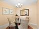 Bright dining room with glass table and four beige chairs at 808 3Rd W Ave # 514, Bradenton, FL 34205