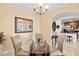 Charming dining area with glass-top table, four chairs and kitchen view at 808 3Rd W Ave # 514, Bradenton, FL 34205