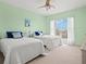 Guest bedroom with two twin beds and light green walls at 808 3Rd W Ave # 514, Bradenton, FL 34205