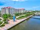 Riverwalk path alongside the water with palm trees and building at 808 3Rd W Ave # 514, Bradenton, FL 34205