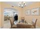 Elegant dining area with a glass-top table and view to living room at 808 3Rd W Ave # 514, Bradenton, FL 34205