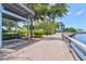 Relaxing walkway with a covered bench and lush landscaping at 808 3Rd W Ave # 514, Bradenton, FL 34205