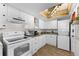 White kitchen with wood floors, and open shelving at 6038 Coral Way, Bradenton, FL 34207