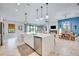 Modern kitchen with white cabinets and a large kitchen island at 9123 Isabella Cir, Parrish, FL 34219