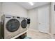 Convenient laundry room with washer, dryer, and ample storage at 9123 Isabella Cir, Parrish, FL 34219