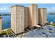 Aerial view of a high-rise building with parking and waterfront location at 5200 Brittany S Dr # 602, St Petersburg, FL 33715