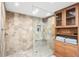 Hexagon tile walk-in shower with built-in bench and pebble flooring at 5200 Brittany S Dr # 602, St Petersburg, FL 33715