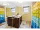 Guest bathroom with double vanity and a colorful shower curtain at 5200 Brittany S Dr # 602, St Petersburg, FL 33715
