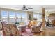 Living room features hardwood floors, floral armchairs, and water views at 5200 Brittany S Dr # 602, St Petersburg, FL 33715