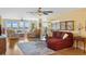 Living room with hardwood floors, sectional sofa, and water views at 5200 Brittany S Dr # 602, St Petersburg, FL 33715