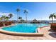Sparkling community pool with palm trees and water views at 5200 Brittany S Dr # 602, St Petersburg, FL 33715