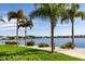 Stunning waterfront view with palm trees and lush landscaping at 5200 Brittany S Dr # 602, St Petersburg, FL 33715