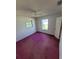 Bedroom with window, ceiling fan, and dark purple carpet at 707 13Th W St, Palmetto, FL 34221