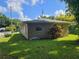 House exterior and grassy backyard at 707 13Th W St, Palmetto, FL 34221