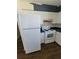 White appliances in a kitchen with blue countertops and white cabinets at 707 13Th W St, Palmetto, FL 34221