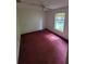 Bedroom with window, ceiling fan and dark purple carpet at 707 13Th W St, Palmetto, FL 34221