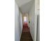 Long hallway with wood-look flooring and carpeted areas leading to other rooms at 707 13Th W St, Palmetto, FL 34221