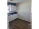 Kitchen with white cabinets, blue countertops, and appliances at 707 13Th W St, Palmetto, FL 34221