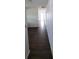 Dark wood-look floors in a hallway with damaged walls leading to other rooms at 707 13Th W St, Palmetto, FL 34221