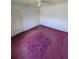 Spacious bedroom with ceiling fan and dark purple carpet at 707 13Th W St, Palmetto, FL 34221