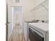 Bright laundry room features washer, dryer, and ample shelving at 10417 Crooked Creek Ct, Parrish, FL 34219