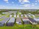 Aerial view of a new residential community with lake and lush green spaces at 10417 Crooked Creek Ct, Parrish, FL 34219
