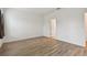 Spacious bedroom with wood-look flooring and access to bathroom at 10417 Crooked Creek Ct, Parrish, FL 34219