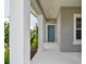 Covered front porch with teal front door at 10417 Crooked Creek Ct, Parrish, FL 34219