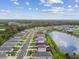 Aerial view of a neighborhood with houses and a pond at 10417 Crooked Creek Ct, Parrish, FL 34219