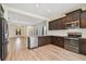 Modern kitchen with island, stainless steel appliances and open to living room at 10417 Crooked Creek Ct, Parrish, FL 34219