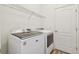 Laundry room with washer, dryer, and overhead shelving at 10417 Crooked Creek Ct, Parrish, FL 34219