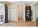 Laundry area with double door storage and wood-look flooring at 10417 Crooked Creek Ct, Parrish, FL 34219