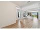 Open concept living area with kitchen views and wood-look flooring at 10417 Crooked Creek Ct, Parrish, FL 34219
