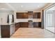 Modern kitchen featuring dark cabinetry, granite counters, and stainless steel appliances at 10417 Crooked Creek Ct, Parrish, FL 34219