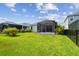 Private backyard with screened patio and lush lawn at 10417 Crooked Creek Ct, Parrish, FL 34219