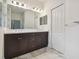 Modern bathroom featuring a double vanity and marble flooring at 10417 Crooked Creek Ct, Parrish, FL 34219