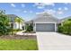 Gray house with gray garage door and landscaping at 10417 Crooked Creek Ct, Parrish, FL 34219