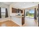 Modern kitchen with granite counters, stainless steel appliances, and backyard access at 10417 Crooked Creek Ct, Parrish, FL 34219