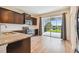 Kitchen with dark cabinetry, granite countertops, and sliding glass doors to patio at 10417 Crooked Creek Ct, Parrish, FL 34219