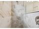 Walk-in shower with marble tile and glass enclosure at 10417 Crooked Creek Ct, Parrish, FL 34219