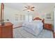 Cozy bedroom with a ceiling fan and wood flooring at 26336 Nadir Rd # 12, Punta Gorda, FL 33983