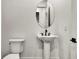 Modern bathroom with a pedestal sink and black fixtures at 17931 Palmiste Dr, Bradenton, FL 34202