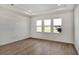 Bedroom with hardwood floors and three windows at 17931 Palmiste Dr, Bradenton, FL 34202