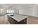 Modern kitchen with large island, white and dark cabinets, and quartz countertops at 17931 Palmiste Dr, Bradenton, FL 34202