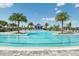Long community lap pool with palm trees and lounge chairs alongside at 17931 Palmiste Dr, Bradenton, FL 34202